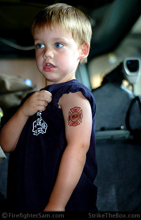 Firefighter Sam shows off his ink.